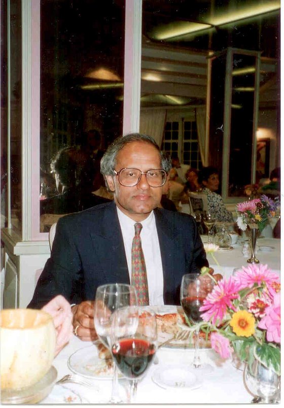 Sanjaya Lall seated at a dinner table