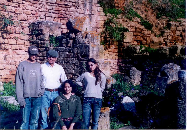 Sanjaya Lall with his family beside ancient stone ruins