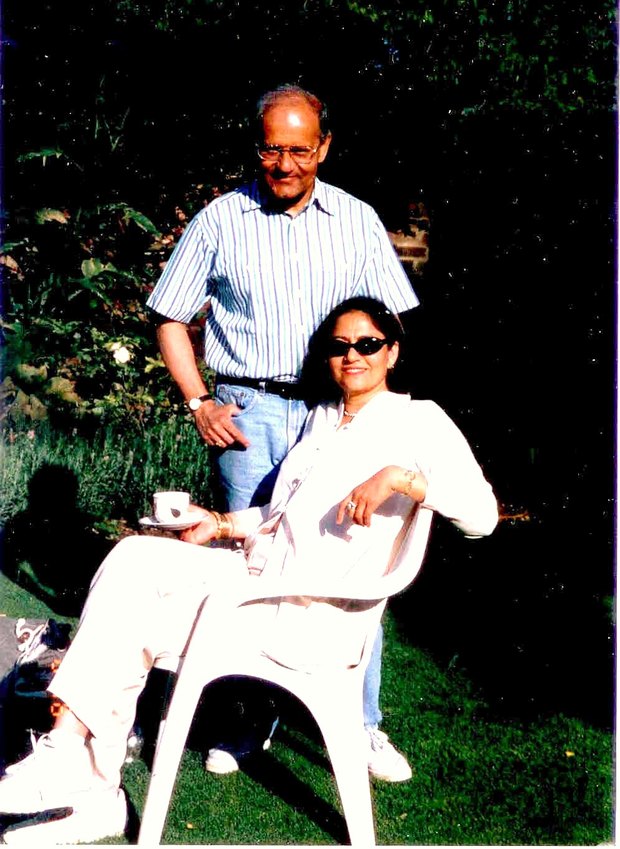 Sanjaya Lall standing beside his wife Rani, seated in a garden